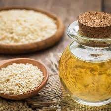 Bottle of Sesame Oil with benefits for cooking, skincare, and hair care displayed. 