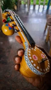 Decorative Bobbili Veena handcrafted from jackfruit wood with intricate carvings and rich tonal quality. 