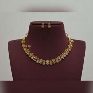 Elegant gold replica necklace set with intricate kundan work, green stones, and pearl embellishments, paired with matching statement earrings, perfect for weddings and festive occasions.