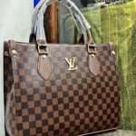 Chic brown Louis Vuitton tote bag crafted from premium crocodile material, showcasing trendy hand block prints, a spacious design, and an adjustable strap for versatile use.