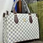 Elegant white Louis Vuitton tote bag made with premium materials, featuring a clean and timeless design, spacious interior, and stylish hand block prints