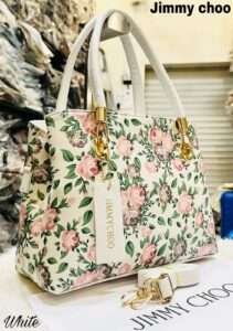 Elegant white handbag featuring a delicate flower design, crafted with premium materials, perfect for adding a touch of sophistication to any outfit.