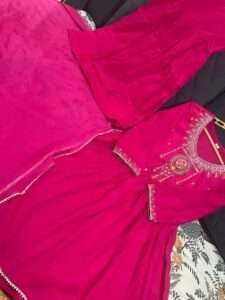 Cotton kurta sharara set with embroidered neck yoke, lacework, and malmal dupatta in pink and blue.