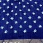 A premium soft silk slub saree featuring indigo batik prints with a matching batik-printed blouse, perfect for casual and festive wear.
