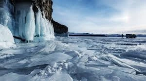 Melting Arctic permafrost under rising temperatures, symbolizing the thawing ground that may release ancient viruses